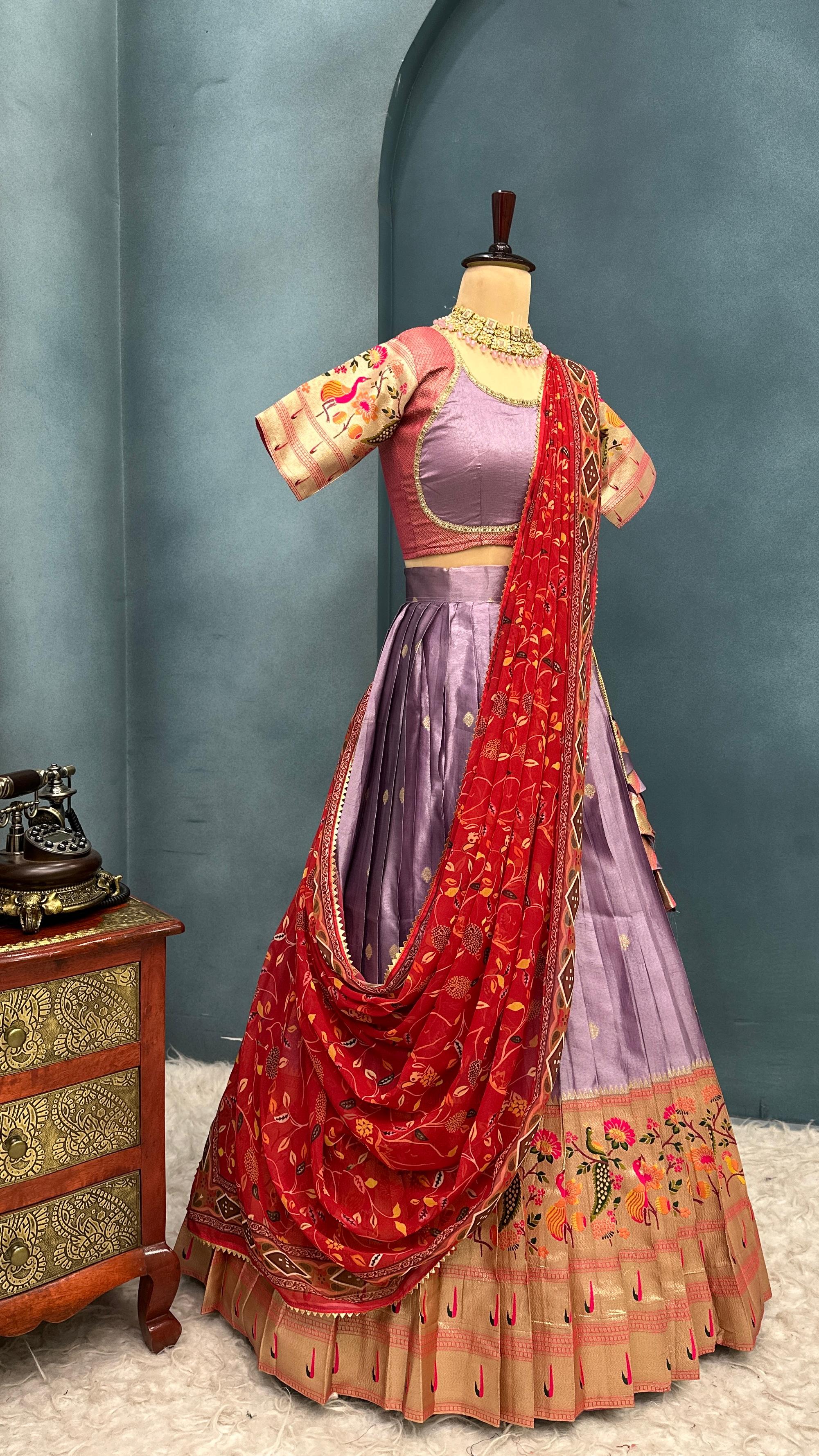 Lavender with Red Traditional Indian outfit on a mannequin against a blue wall.