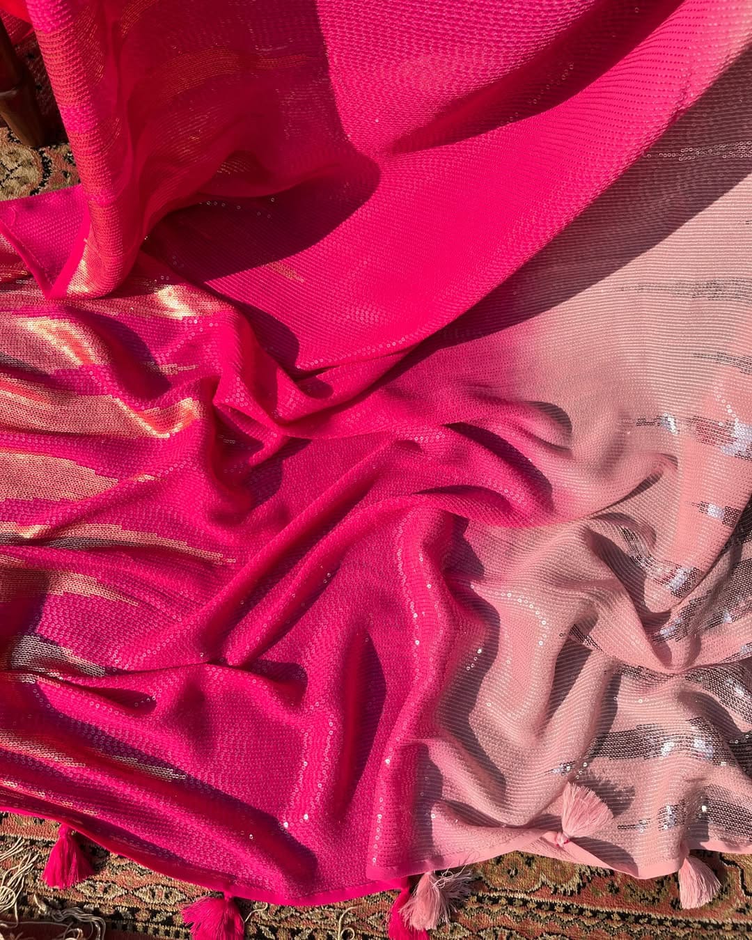 Close-up of pink fabric with a textured pattern on a textured surface