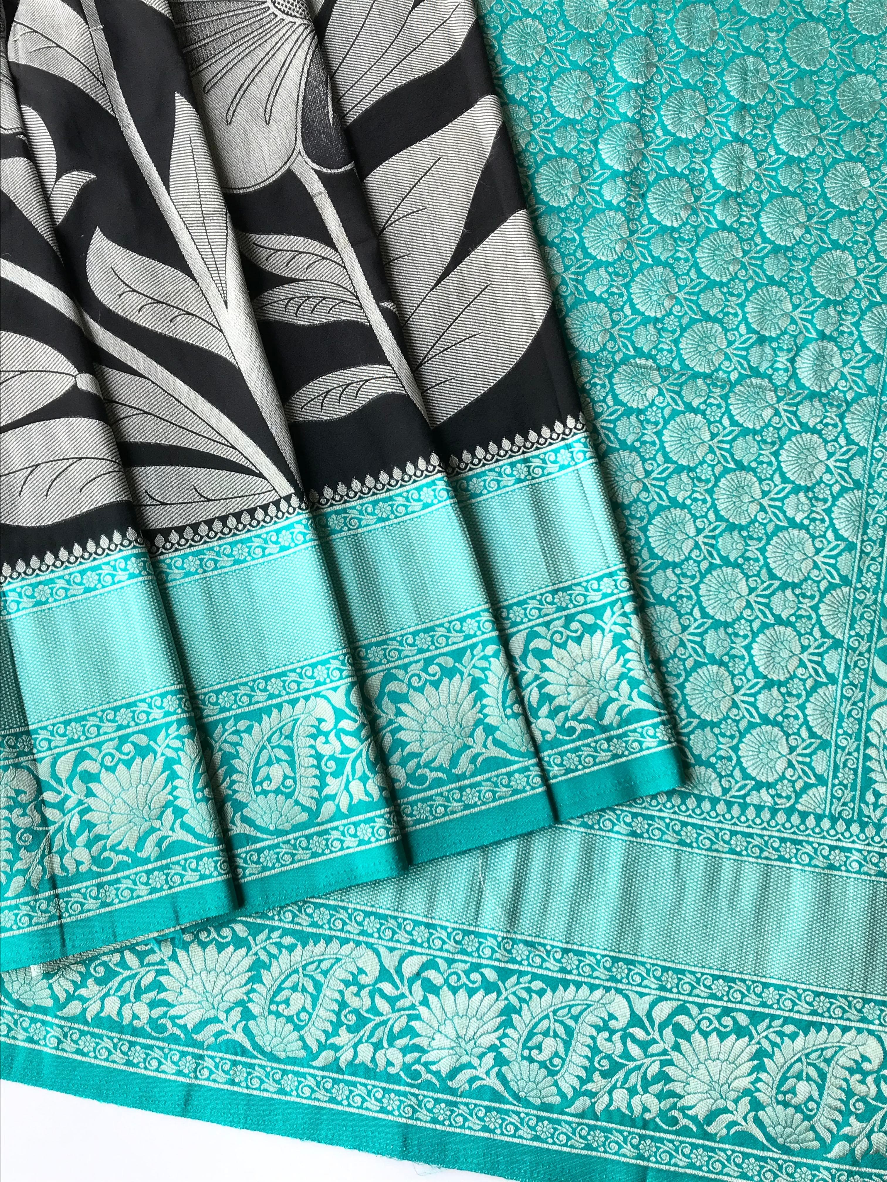 black saree with floral patterns