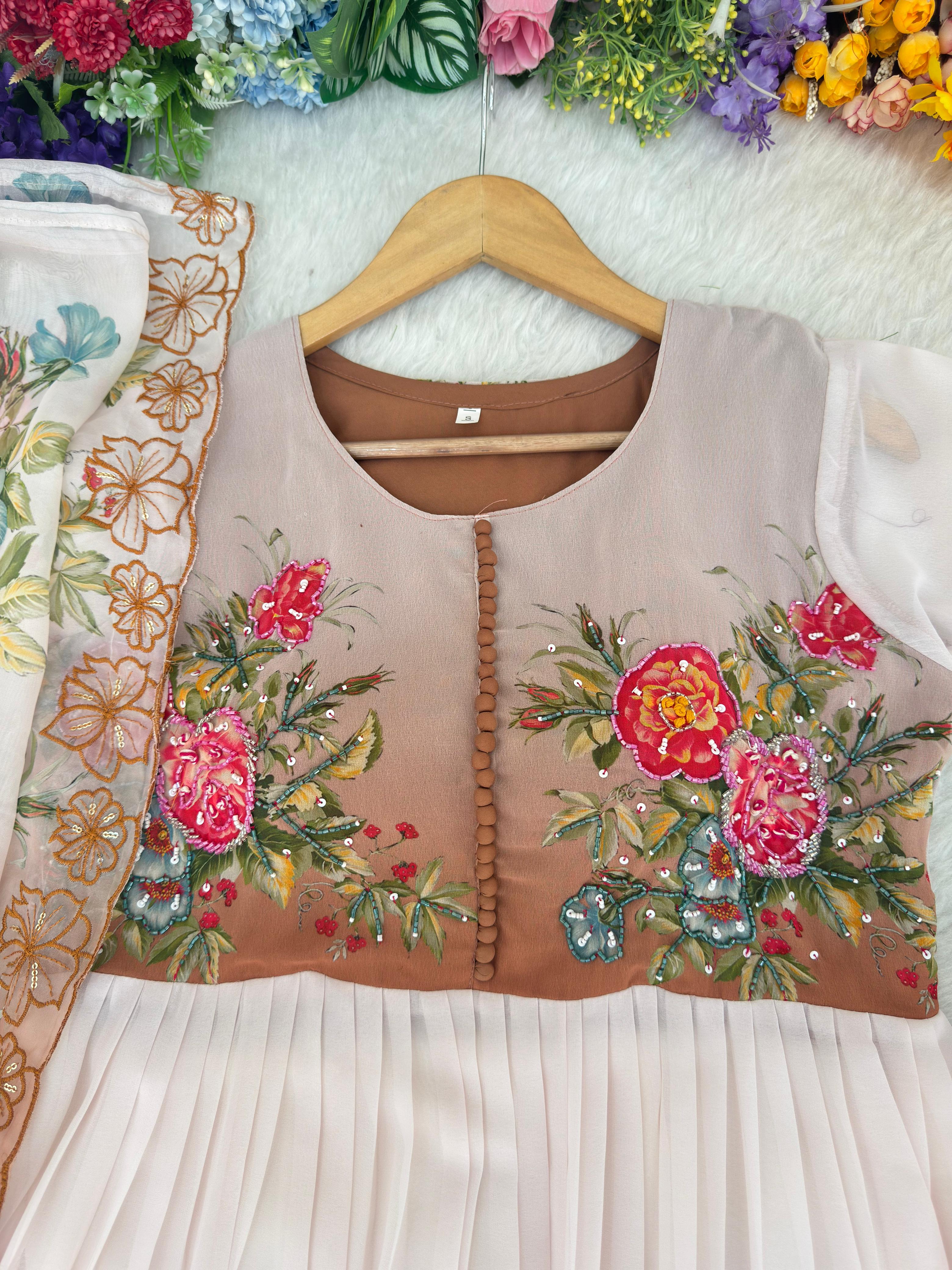 White and brown dress with floral designs on a hanger against a floral background