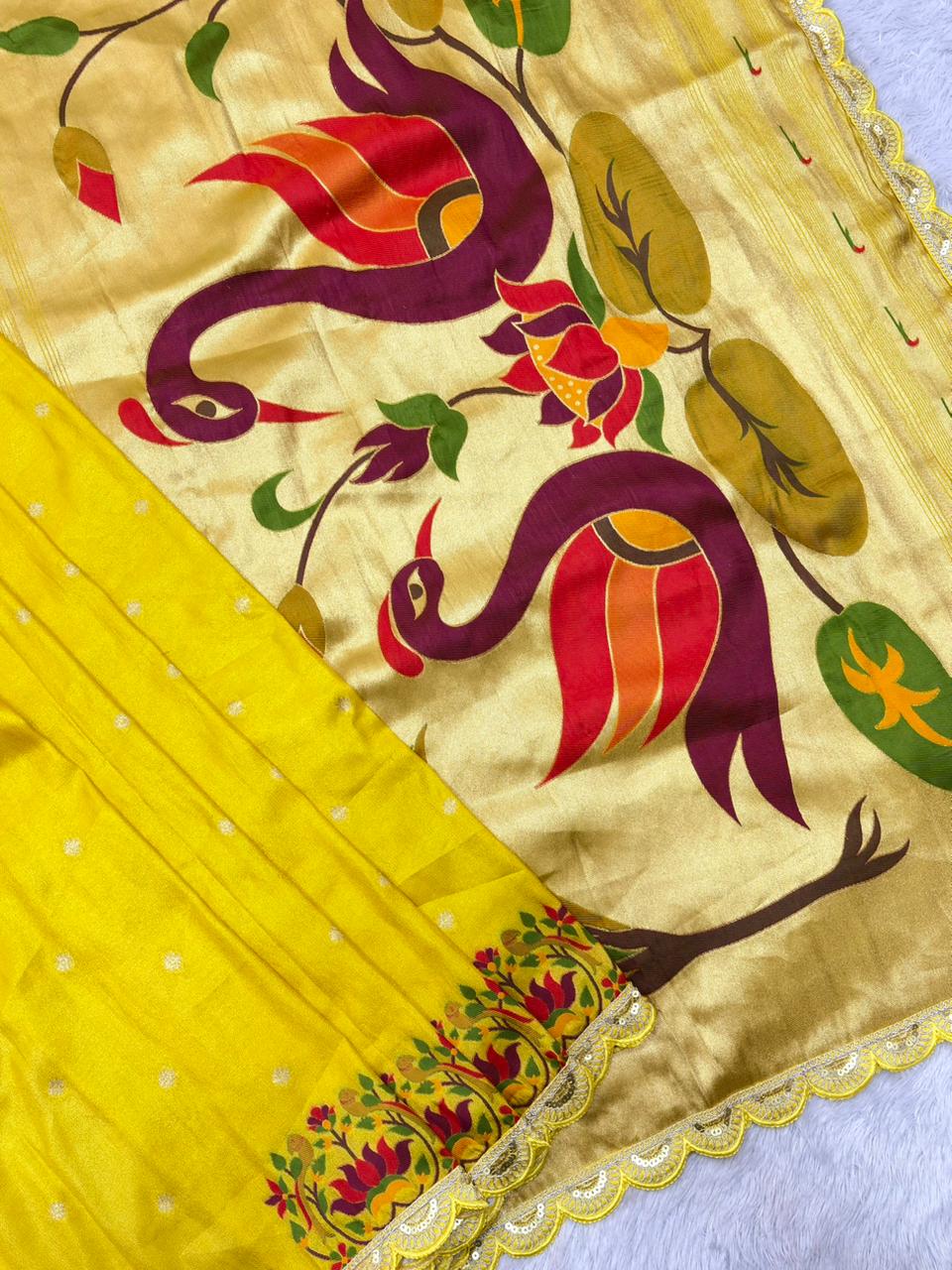 Decorative yellow fabric with colorful dragon design on a background
