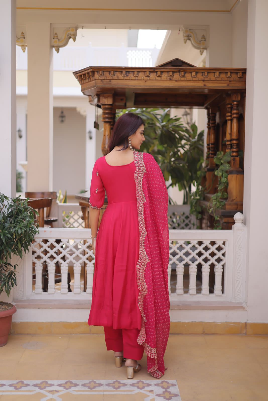 pink traditional outfit with gold accents 