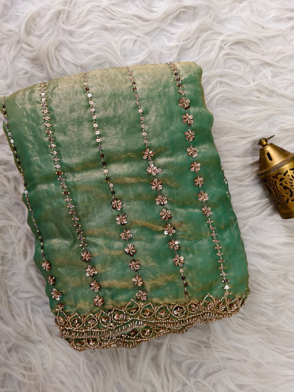 Light Green fabric with floral embroidery on a texture surface