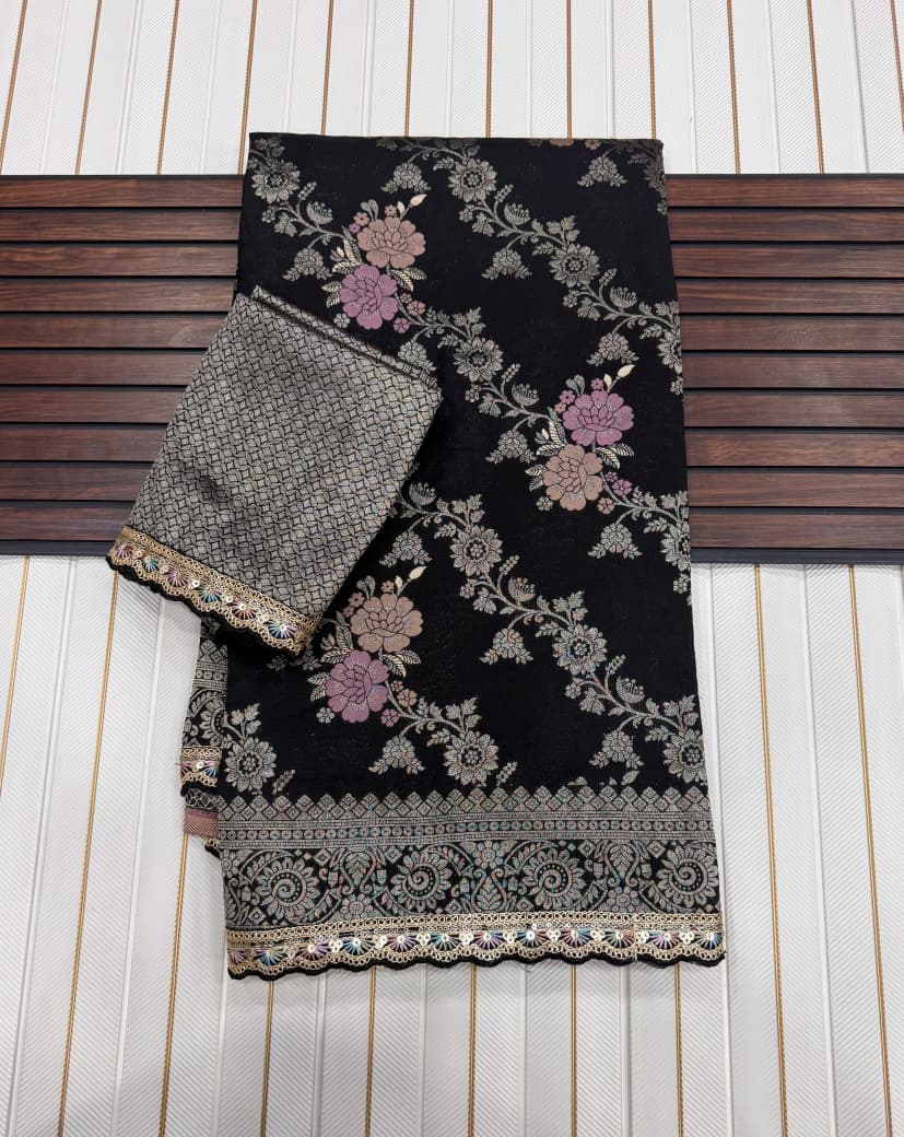 Black embroidered fabric with floral patterns on a wooden surface