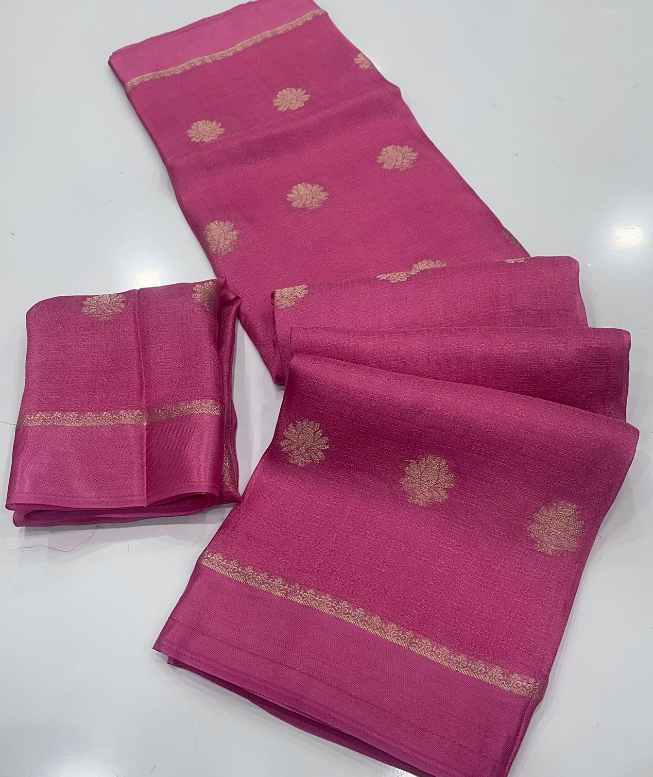 Blush Pink saree with gold border and patterns on a white background
