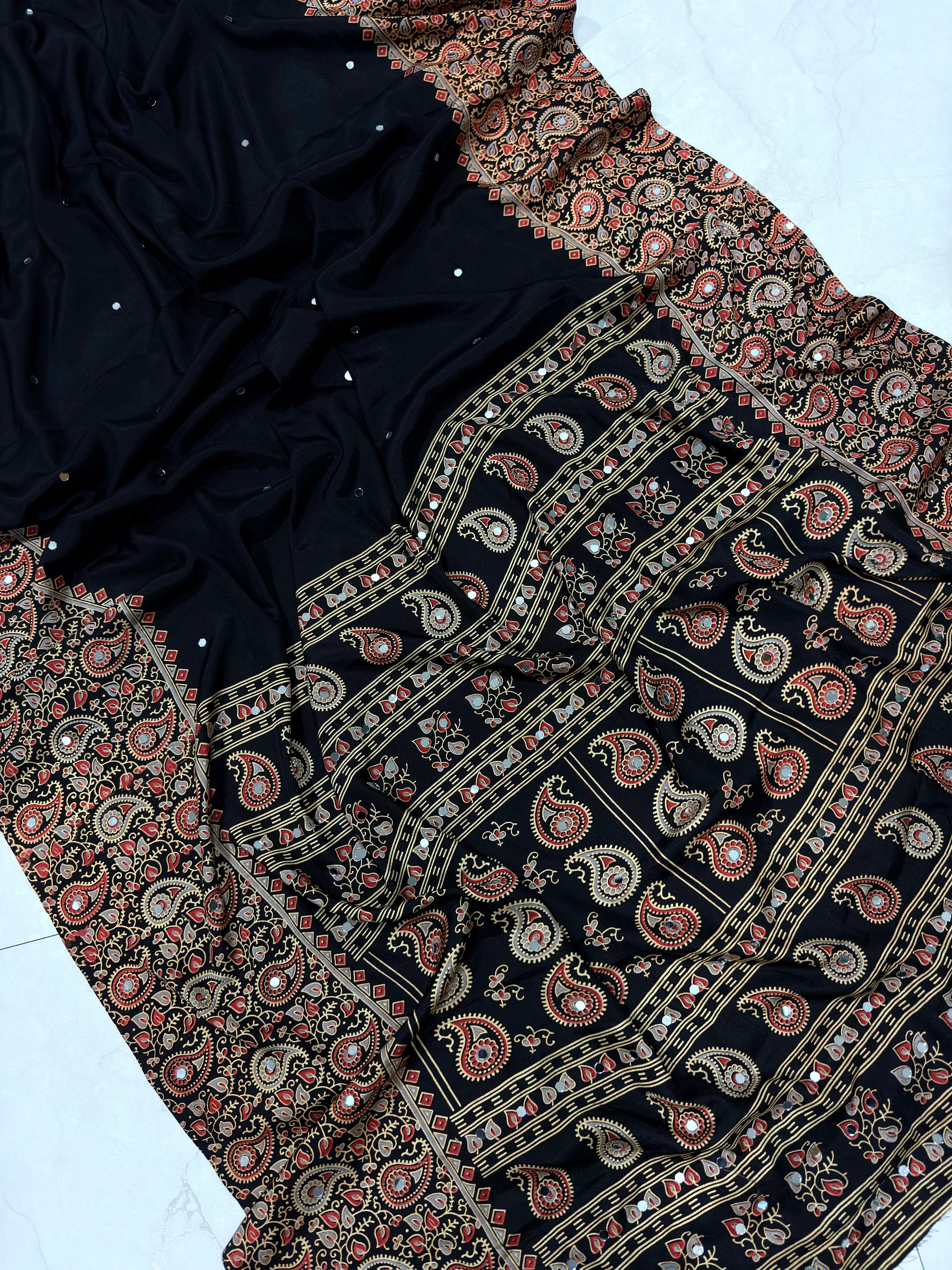 Black fabric with intricate paisley patterns on a white background
