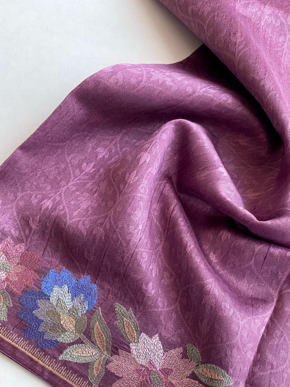 purple fabric with floral embroidery on a background