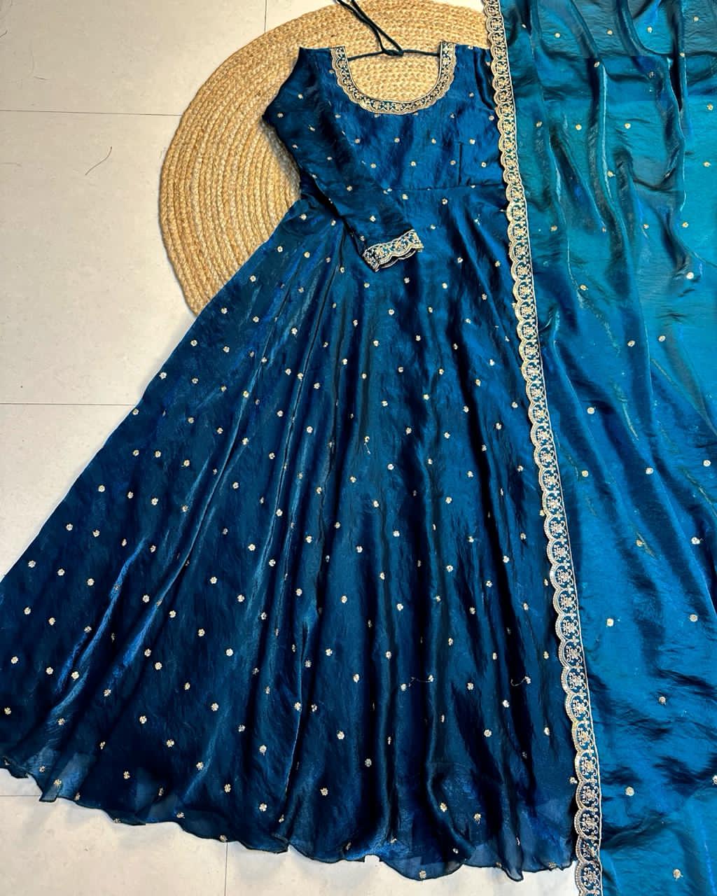 Teal Blue embroidered dress with silver detailing on a light background