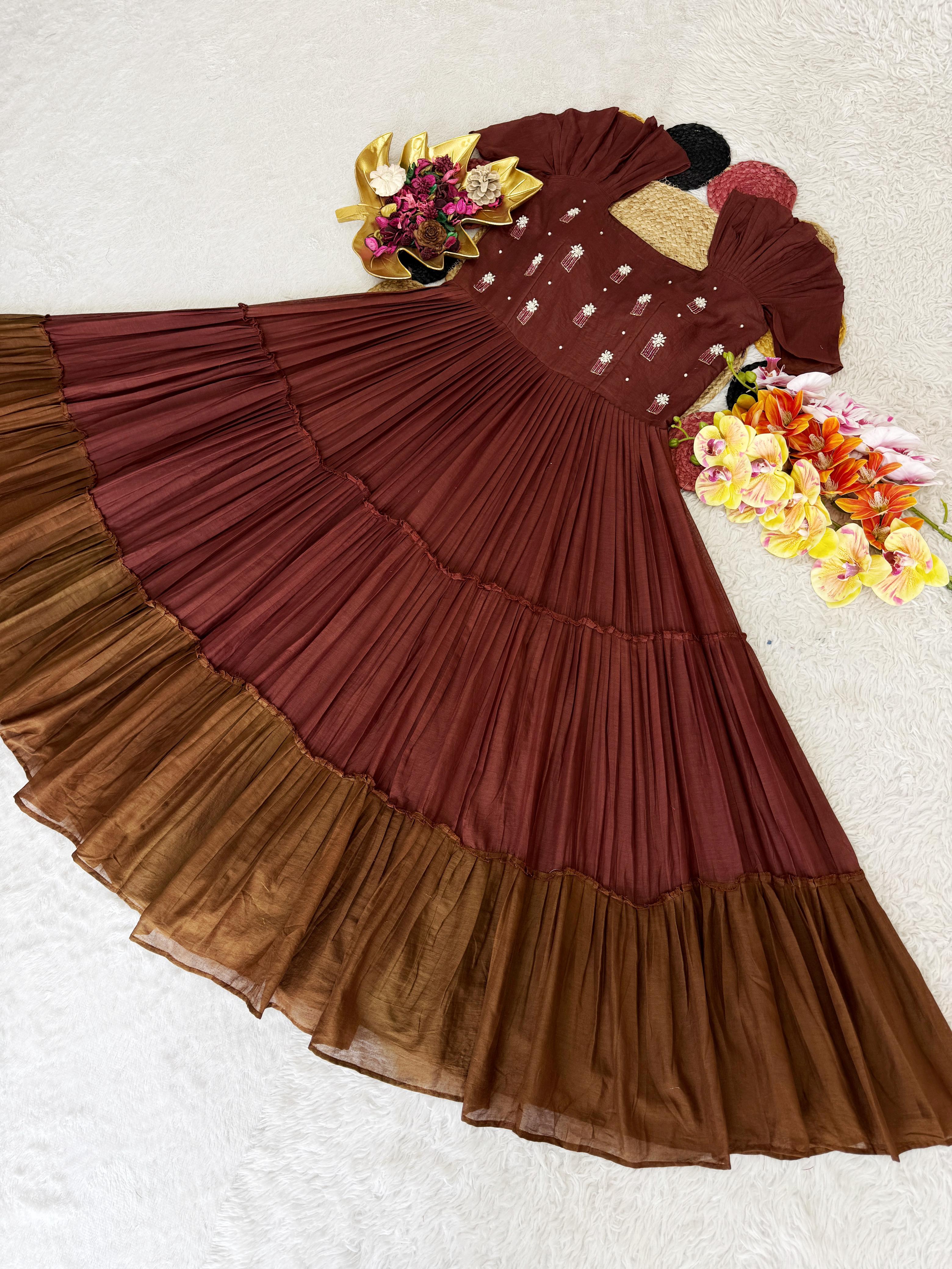 Brown dress with ruffled layers on a white background