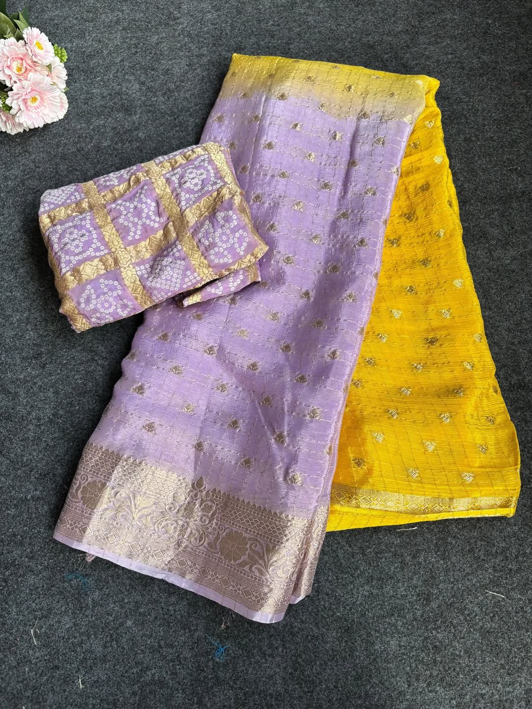 yellow fabric with floral design on a dark surface