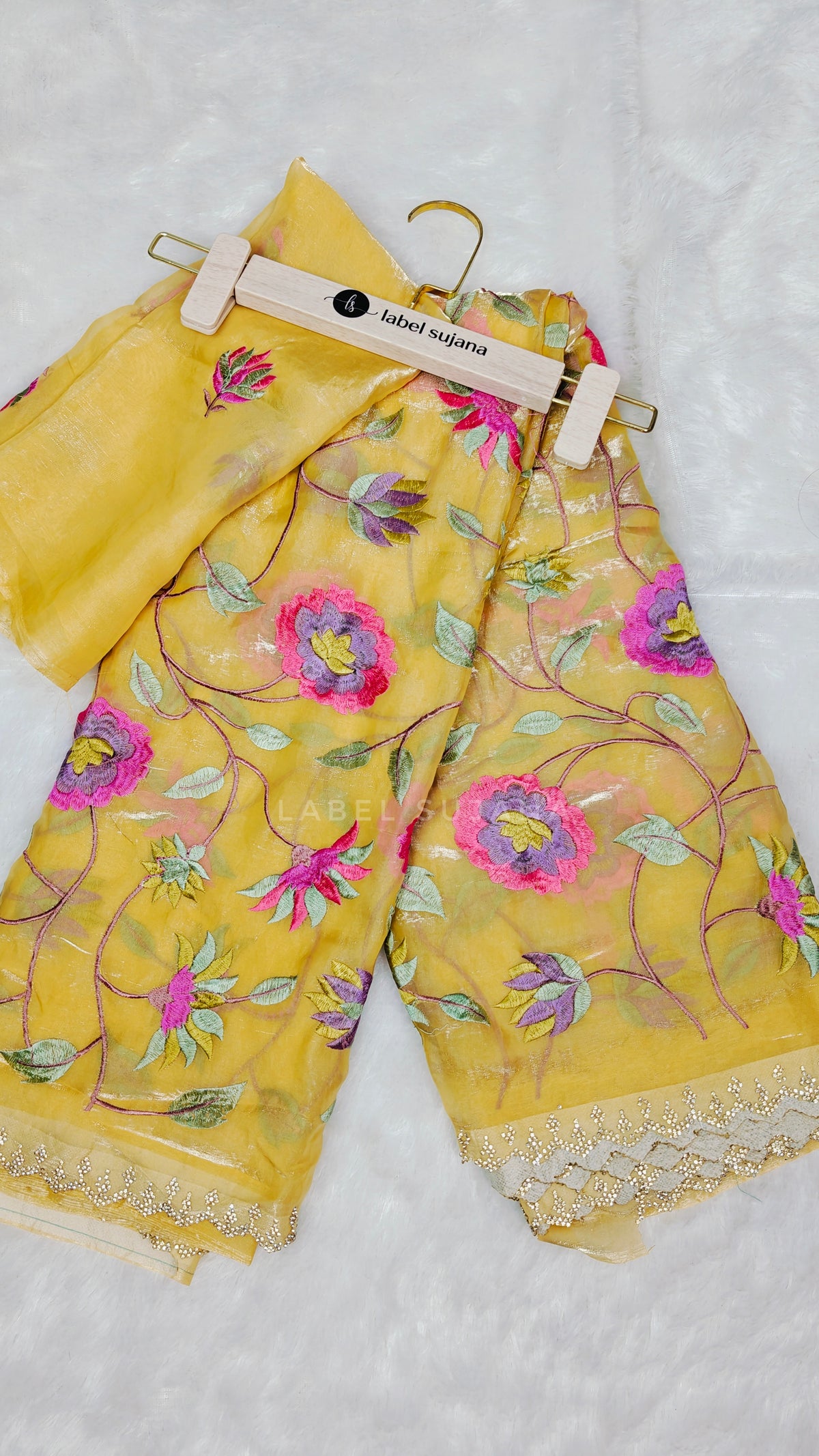 A yellow embroidered saree with matching blouse