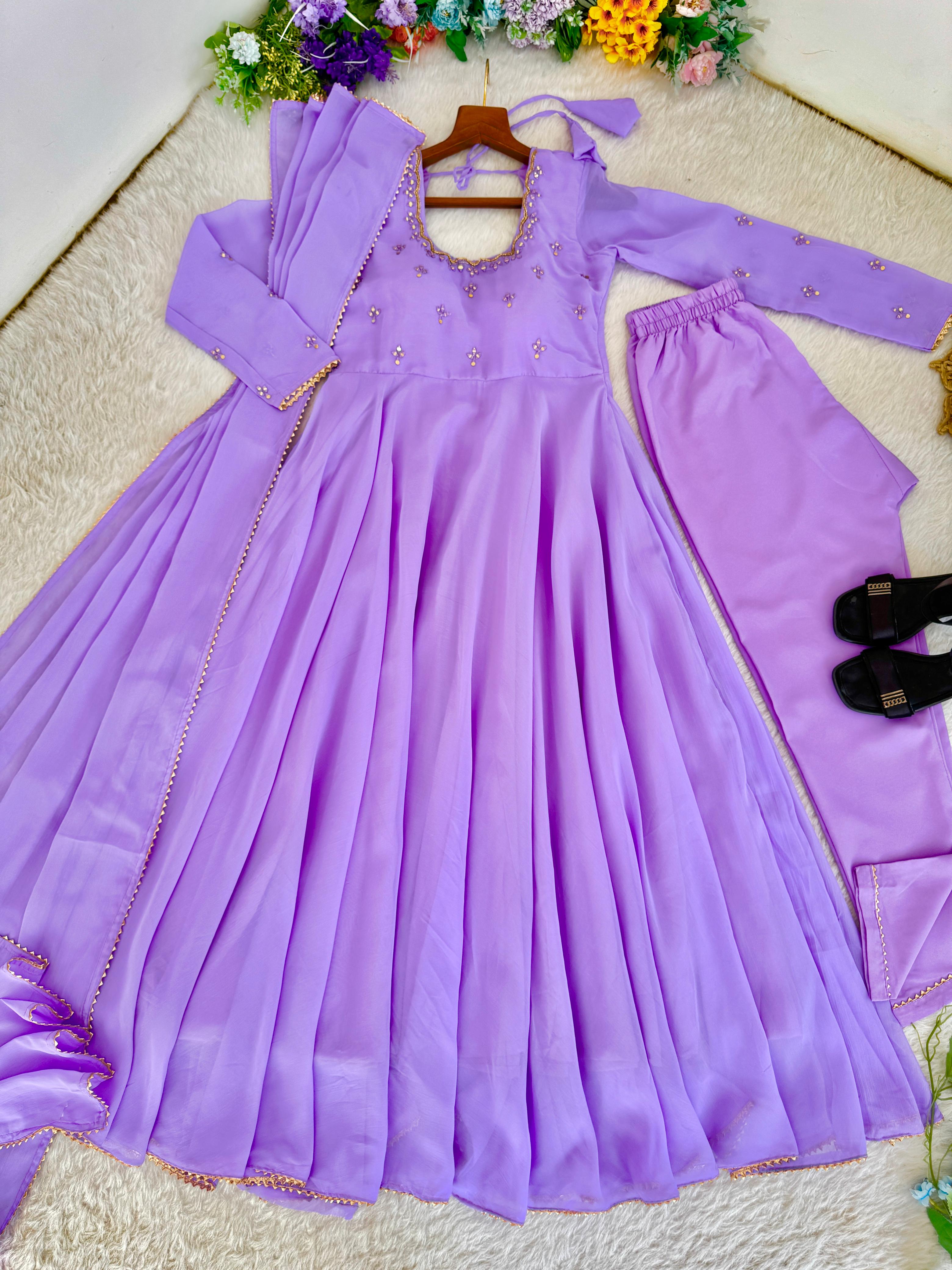 Purple dress with matching pants on a hanger against a floral background