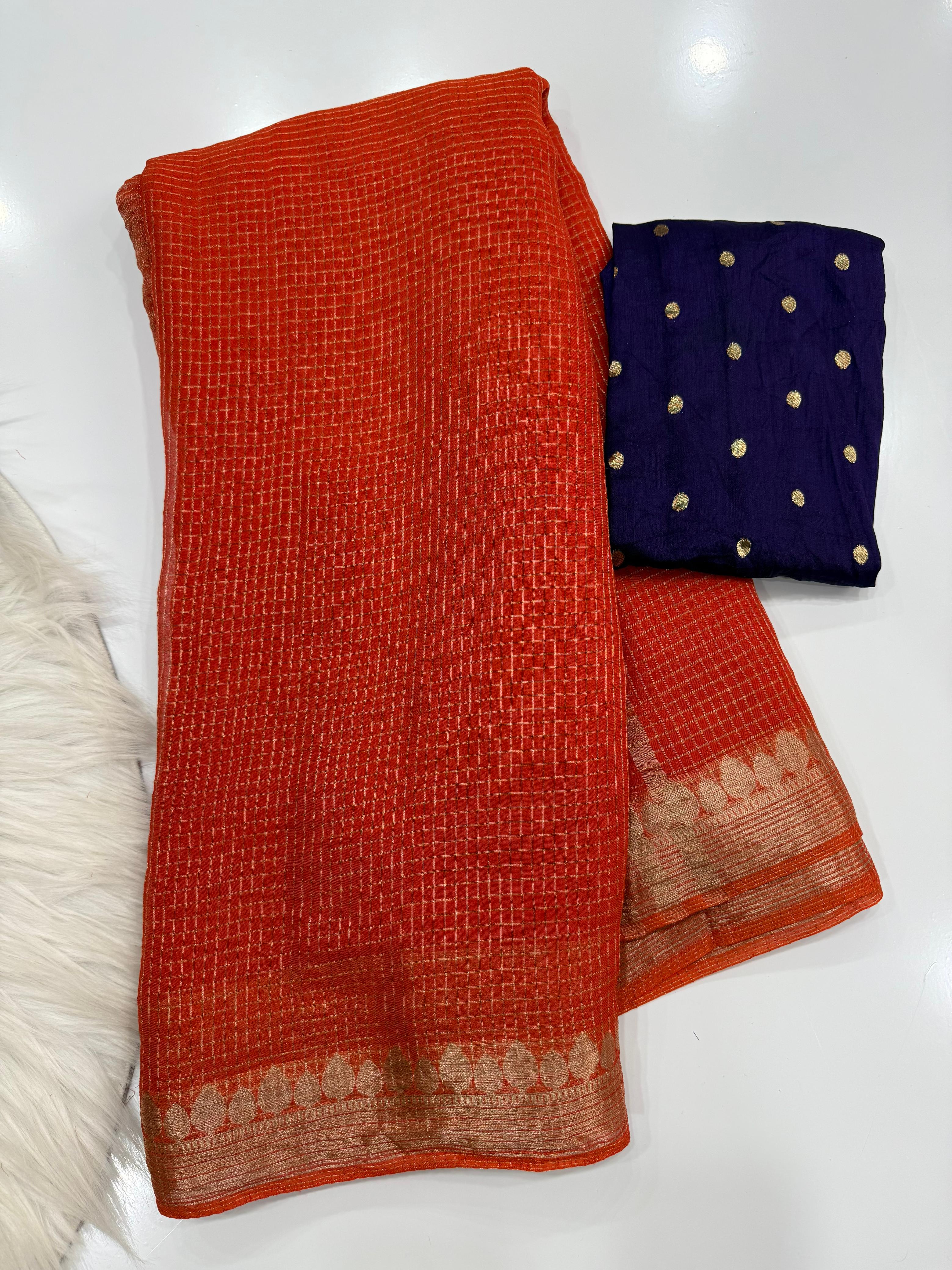 Orange checkered fabric with a blue border featuring gold dots on a white background