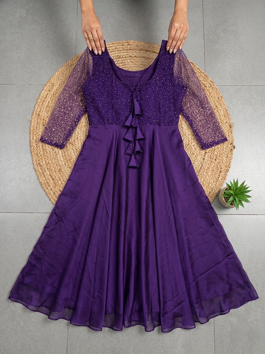 Purple dress with sheer sleeves on a gray background