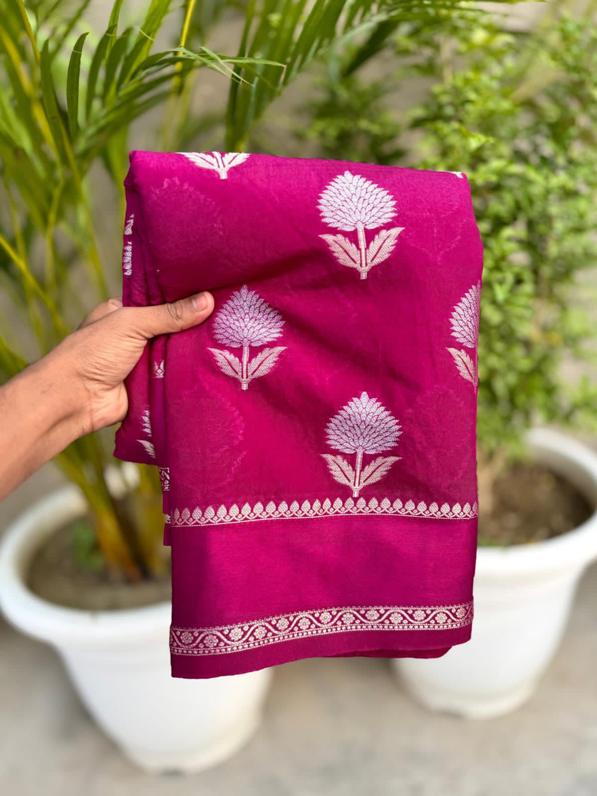 Rani pink fabric with white floral patterns