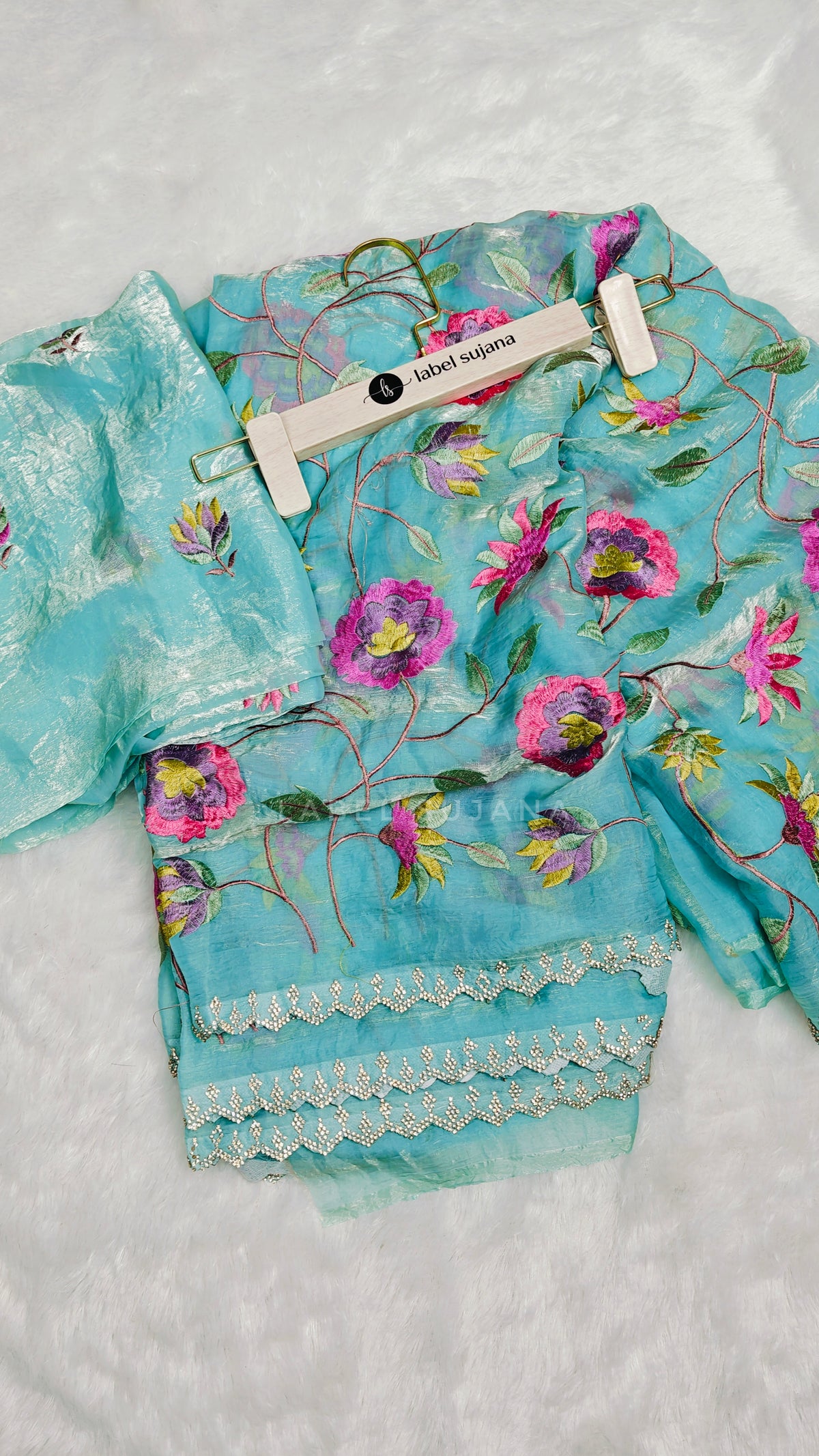 A sky blue embroidery saree with matching embroidery blouse