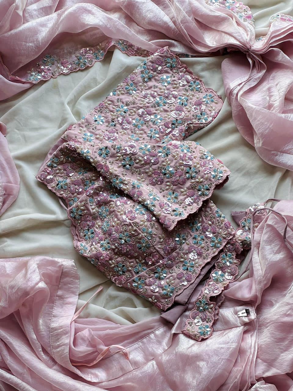 Blush Pink embroidered garment on a light pink fabric background