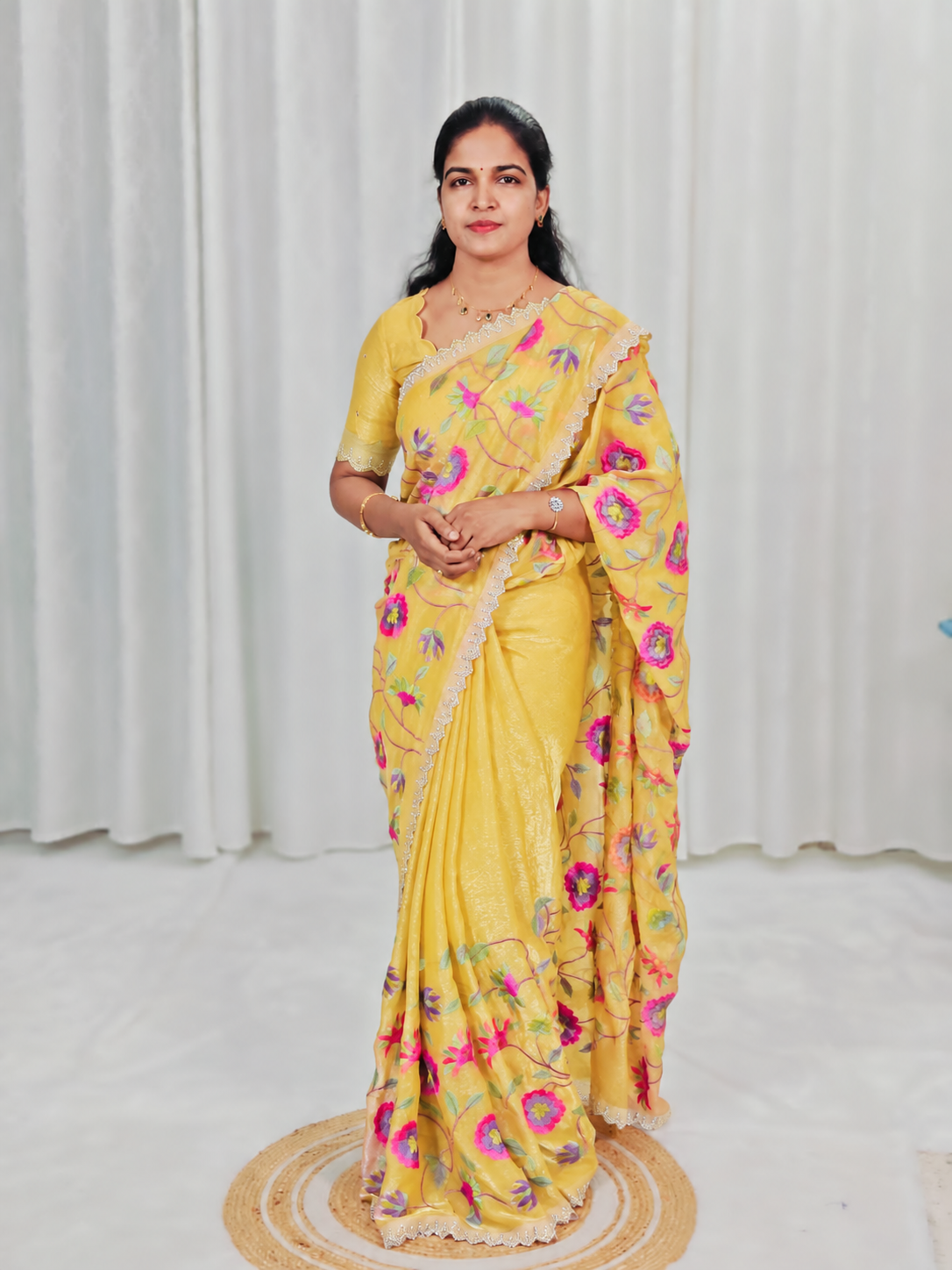 A yellow embroidered saree with matching blouse