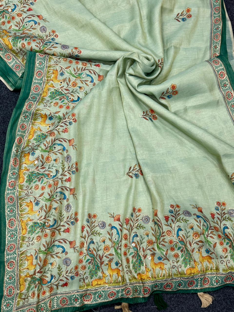 Pista green fabric with colorful floral and animal patterns on a dark background
