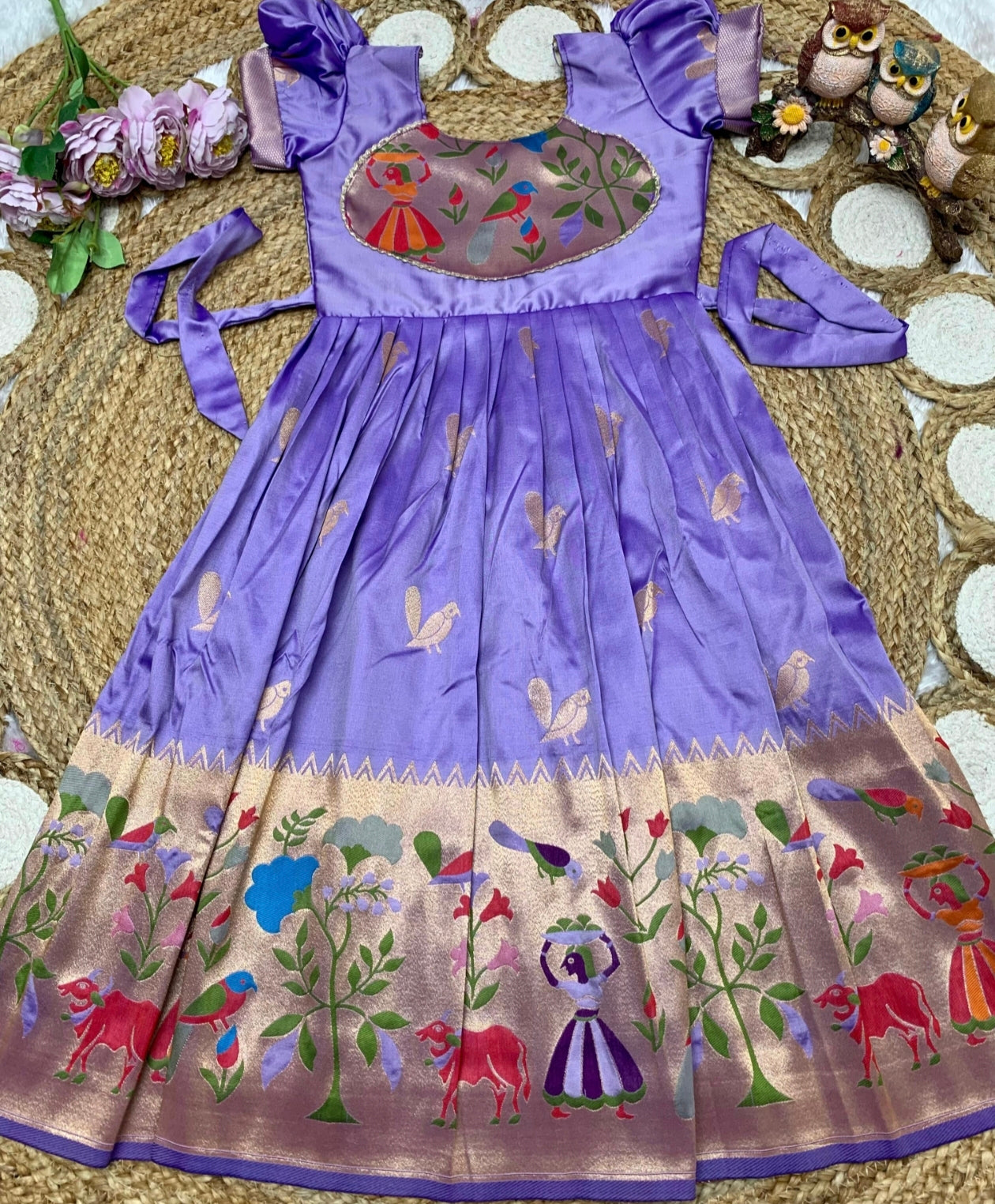 Lavender dress with floral and animal patterns on a texture surface