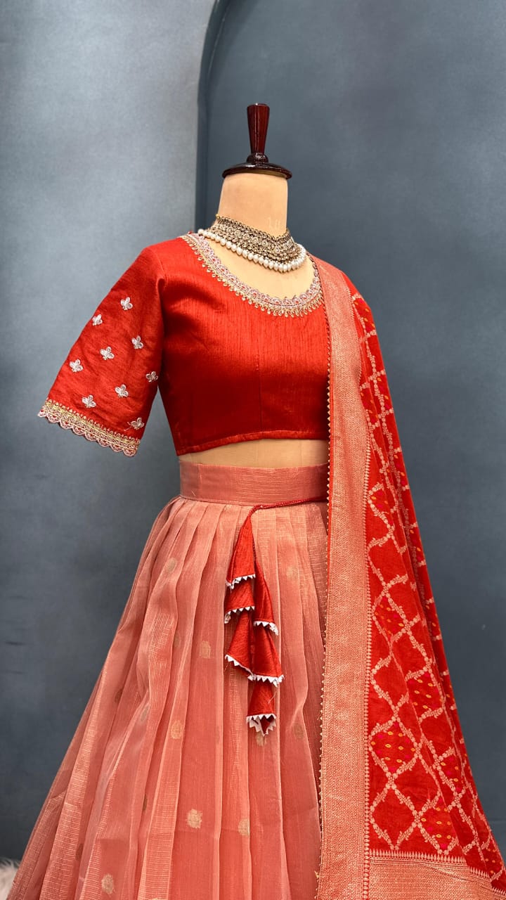 Light orange traditional outfit with a saree on a mannequin against a gray background