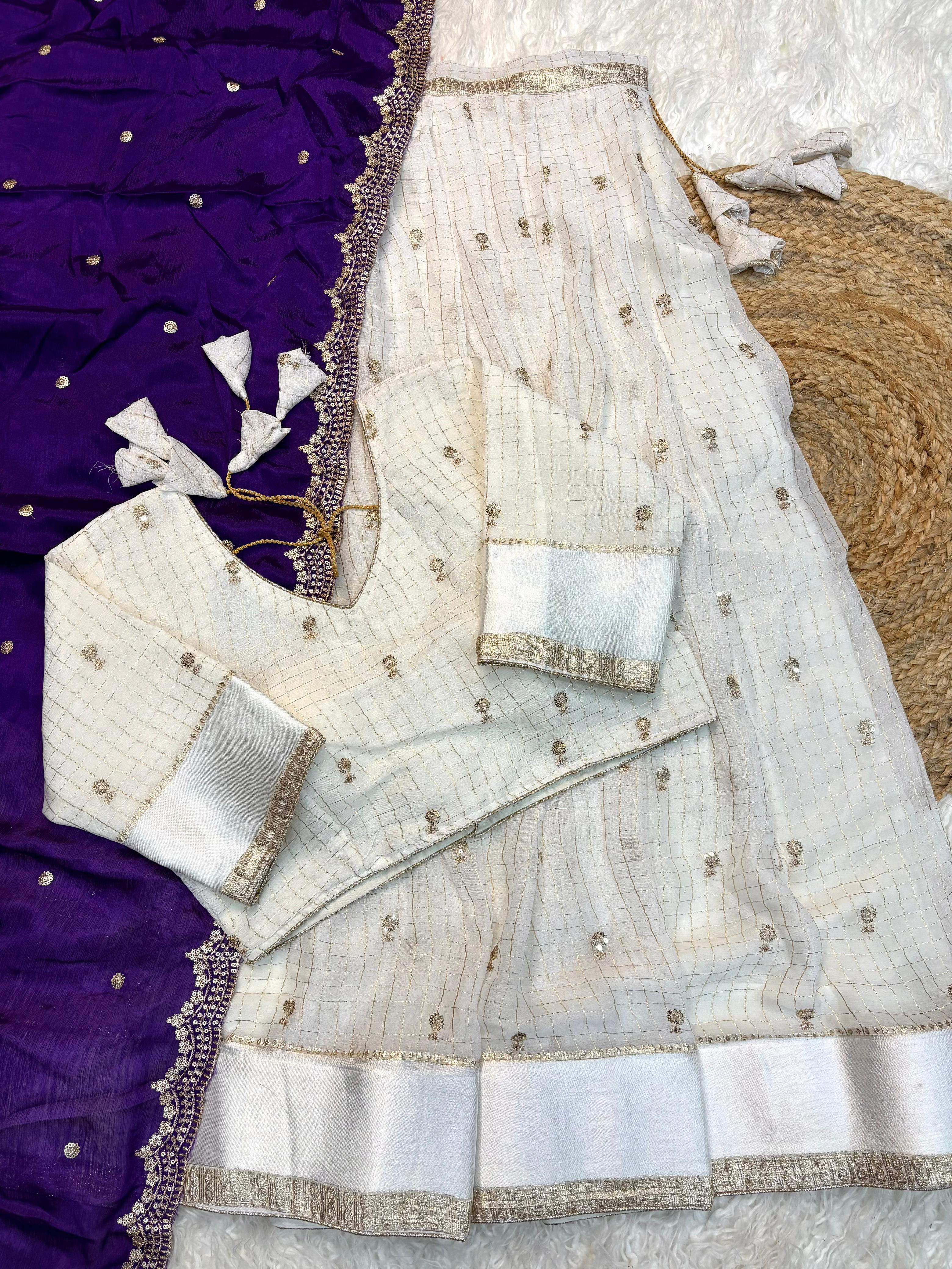 Purple saree with white border on a texture surface