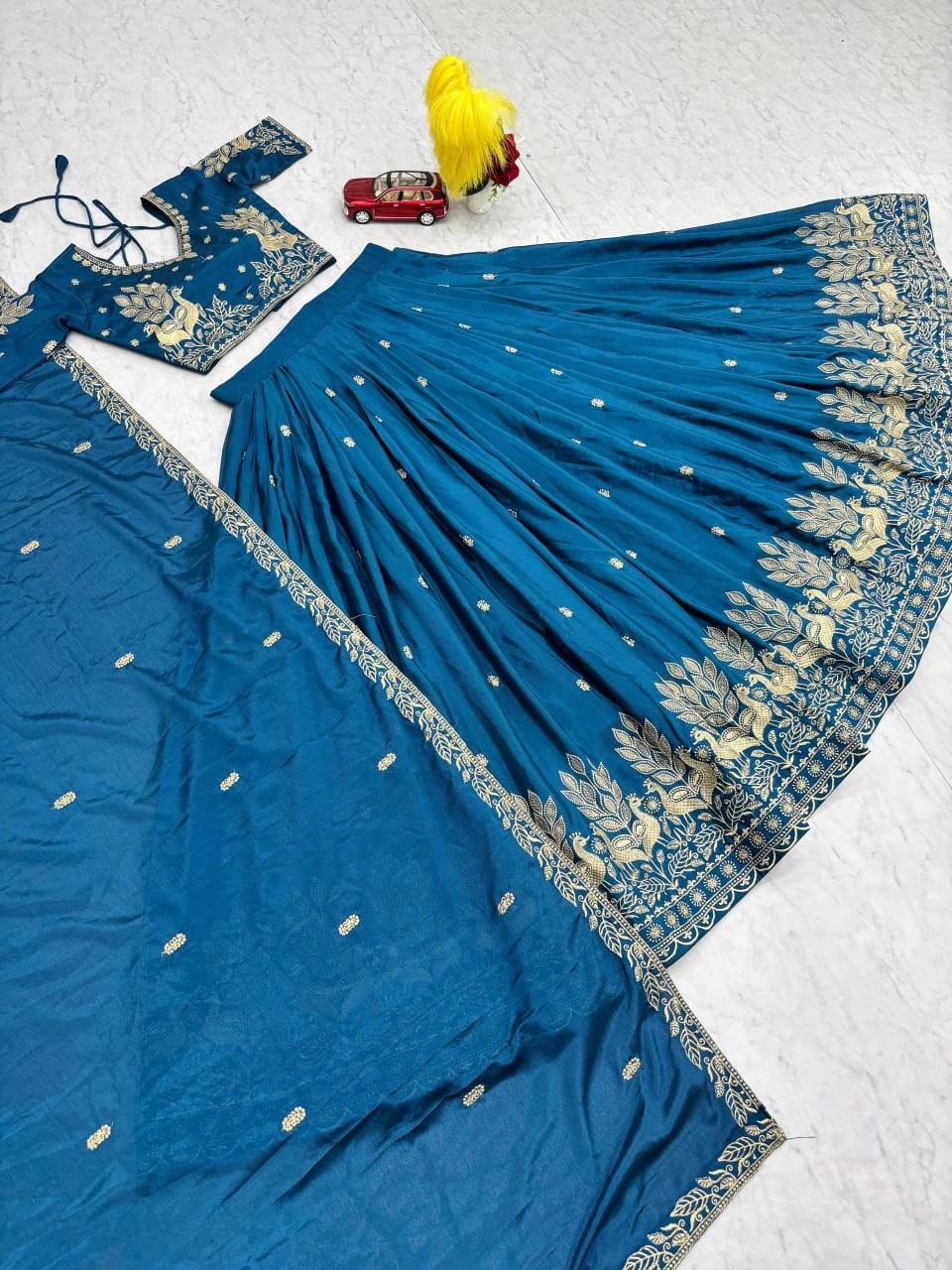 Blue lehenga with gold patterns on a white background