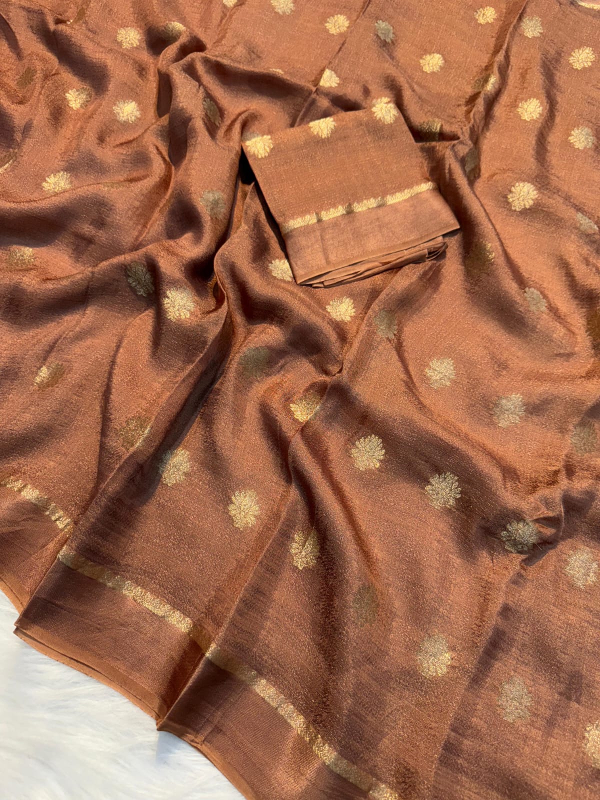 Brown fabric with gold patterns on a white background