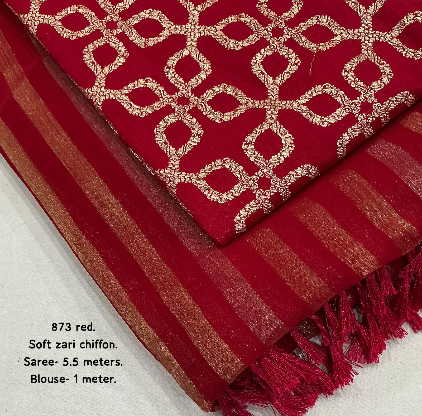 Red saree with gold zari patterns on a white background