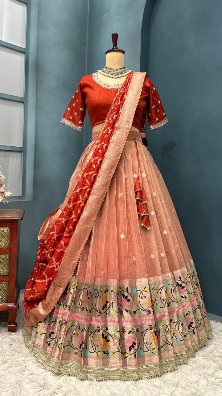 Light orange Traditional Indian outfit on a mannequin against a blue wall.