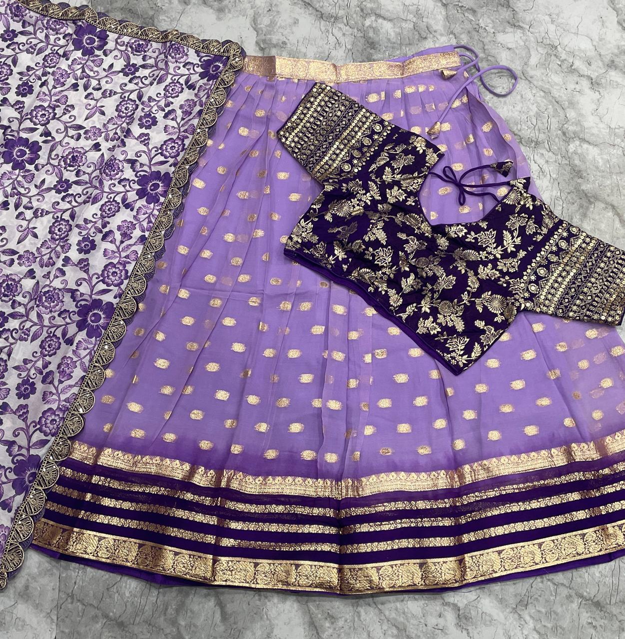 Purple traditional outfit with gold patterns on a textured surface