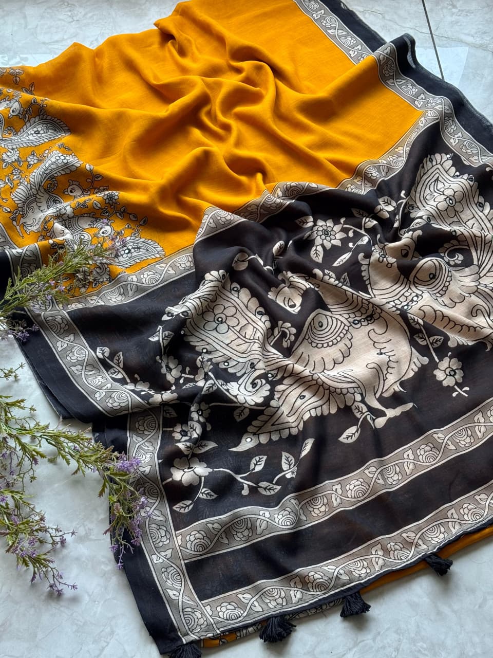 Black and white patterned fabric with yellow fabric partially visible on a light surface.