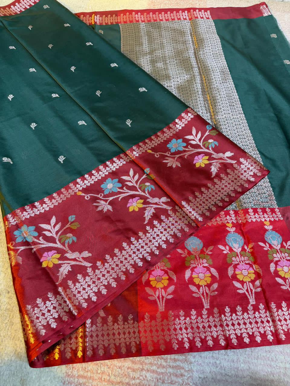 Dark green and one red, on a light background.