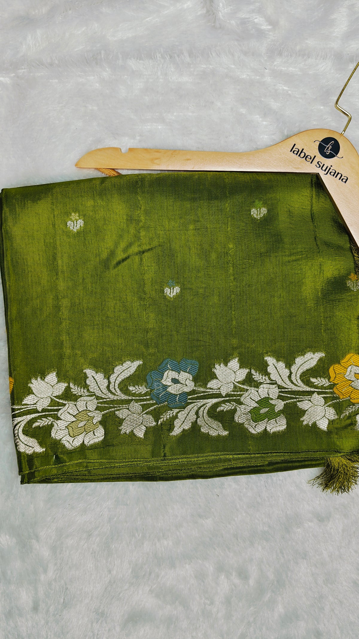 An olive green silk saree