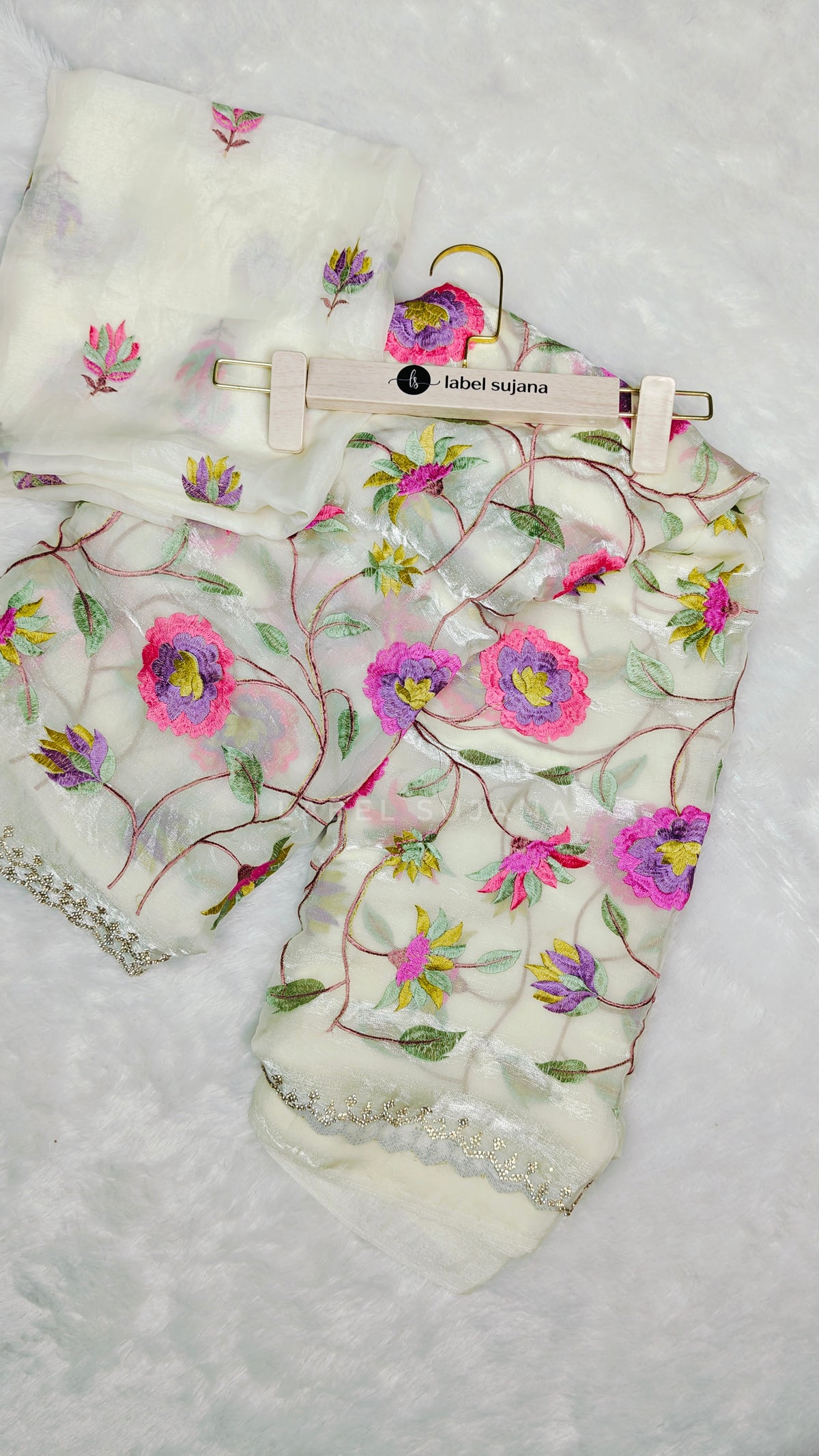 A white embroidery saree with matching blouse 