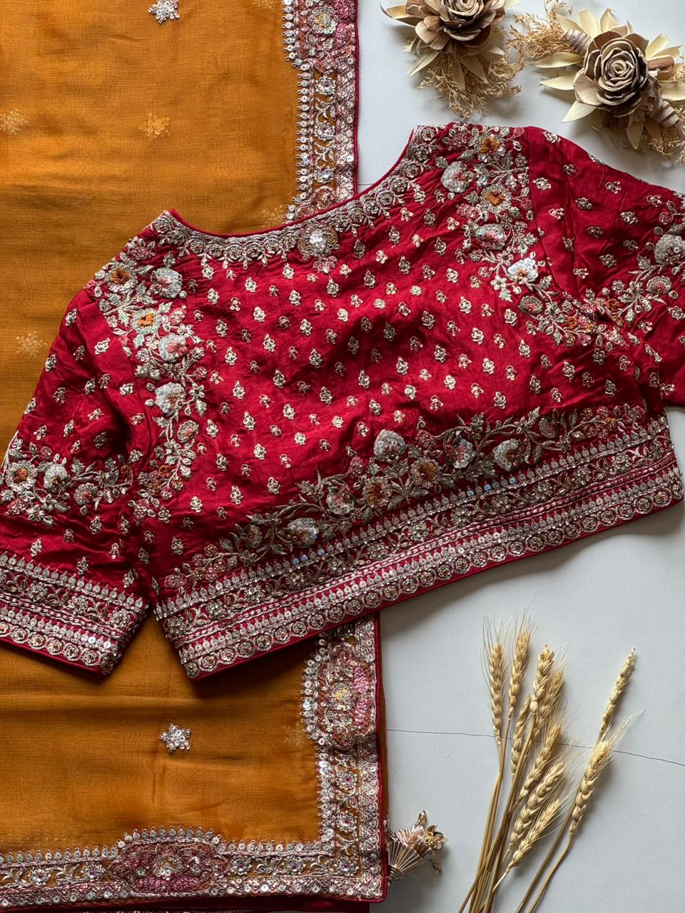 Red embroidered blouse with Mustard Yellow fabric on a wooden surface