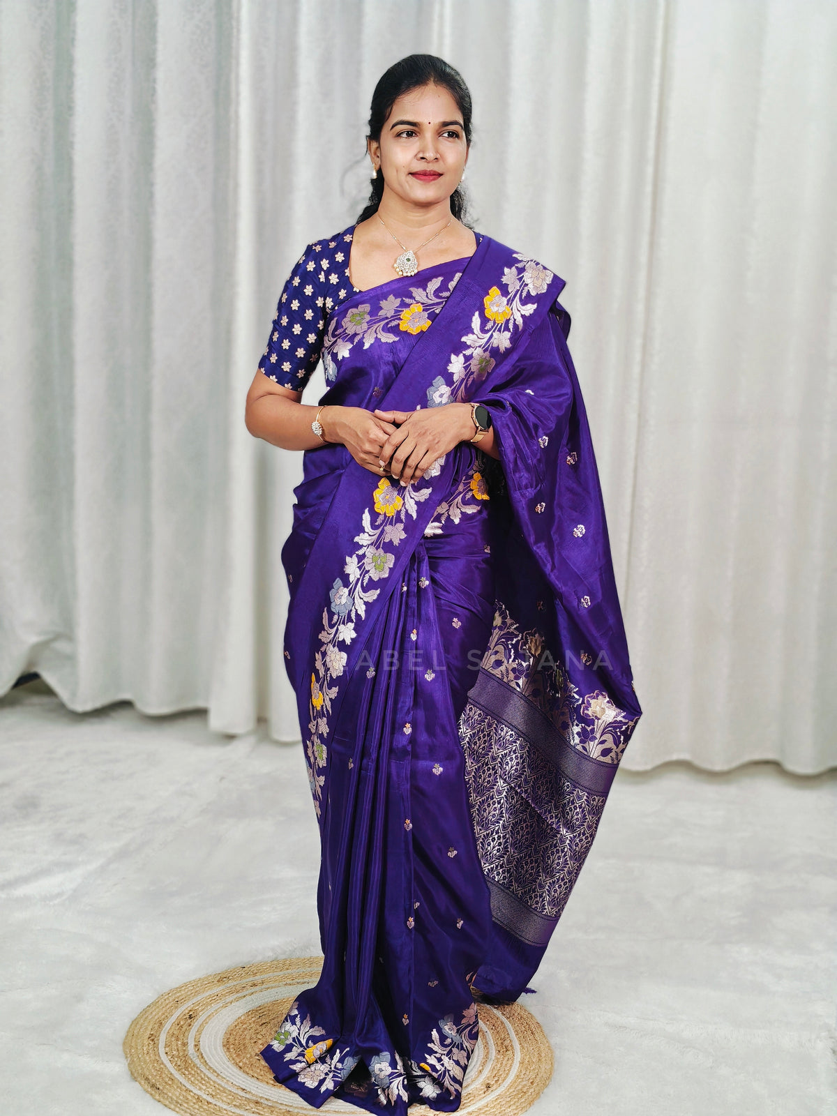 A woman wearing a purple silk saree