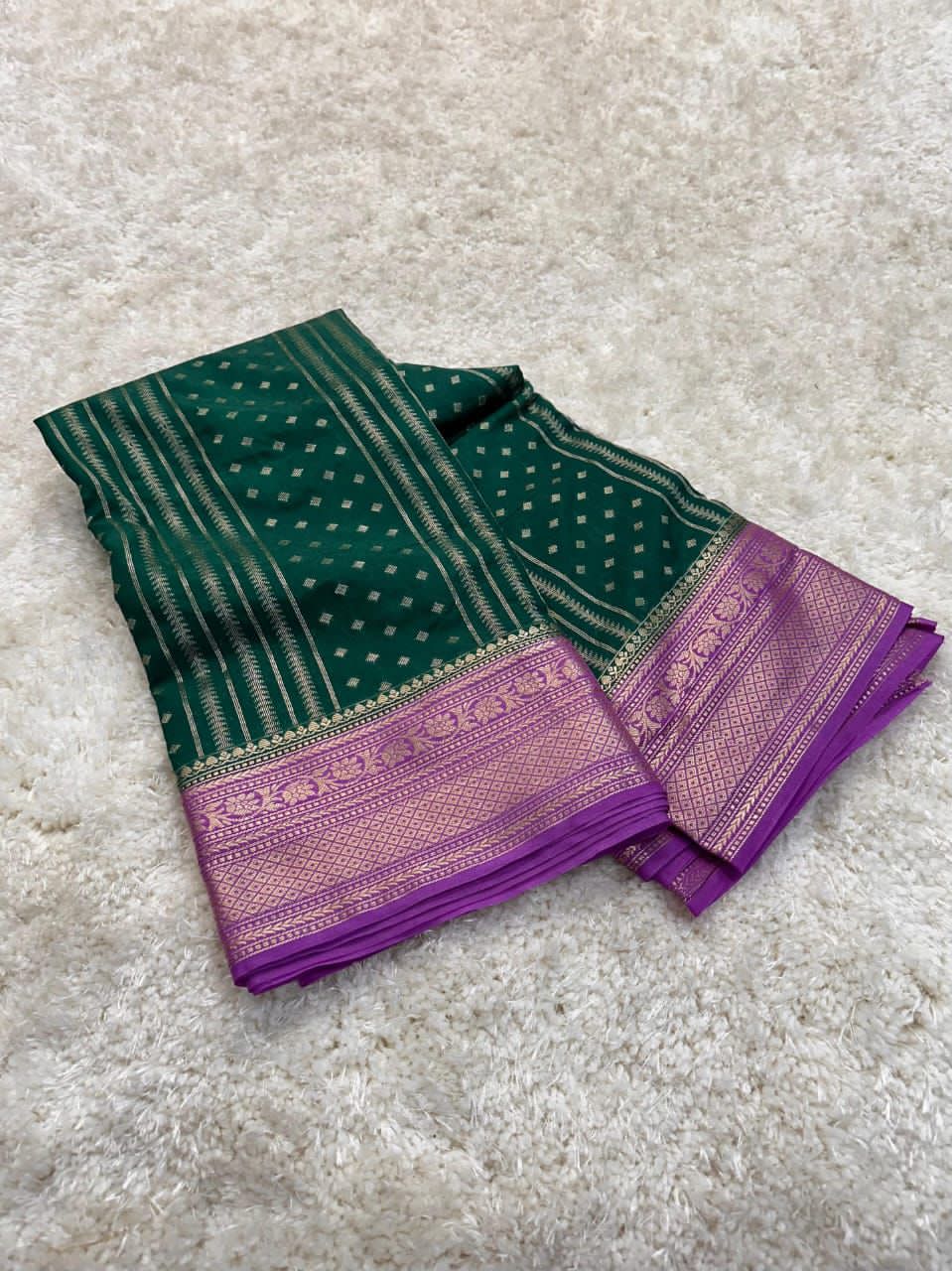 Bottle Green traditional fabric with intricate patterns on a light gray background
