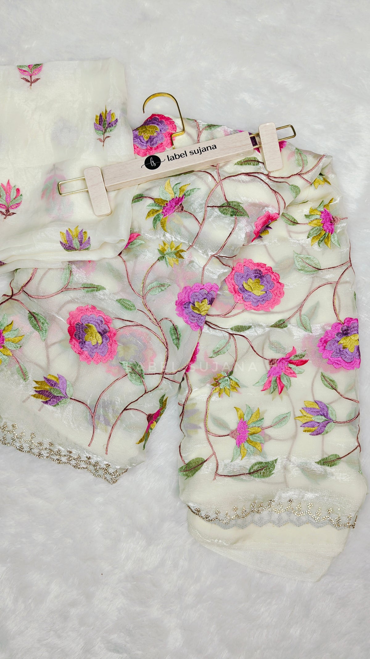 A white embroidery saree with matching blouse 