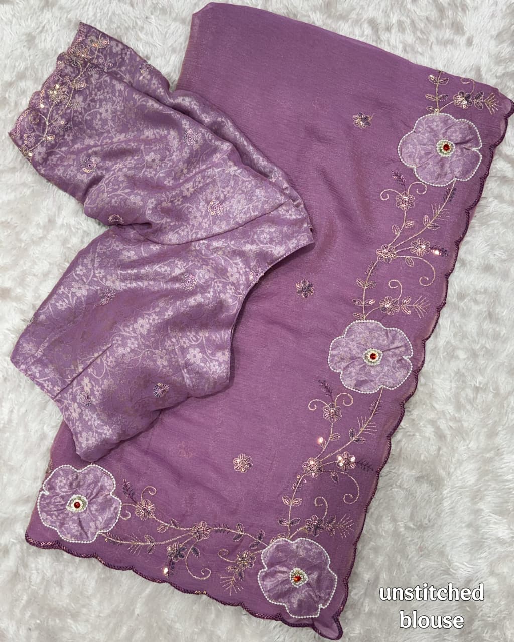 Lavender blouse with floral embroidery on a textured surface