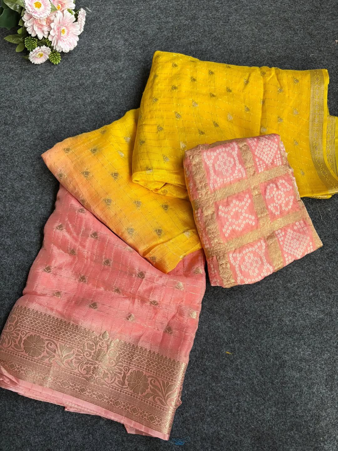 Peach saree with floral decorations on a dark surface