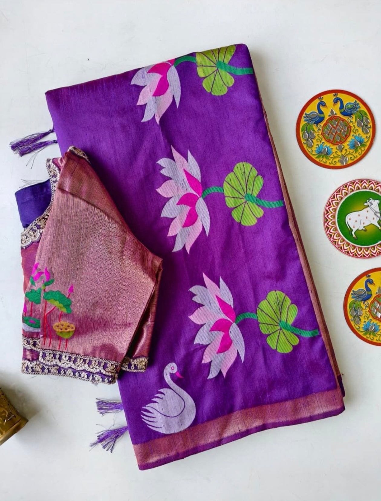 Purple saree with floral patterns on a white background