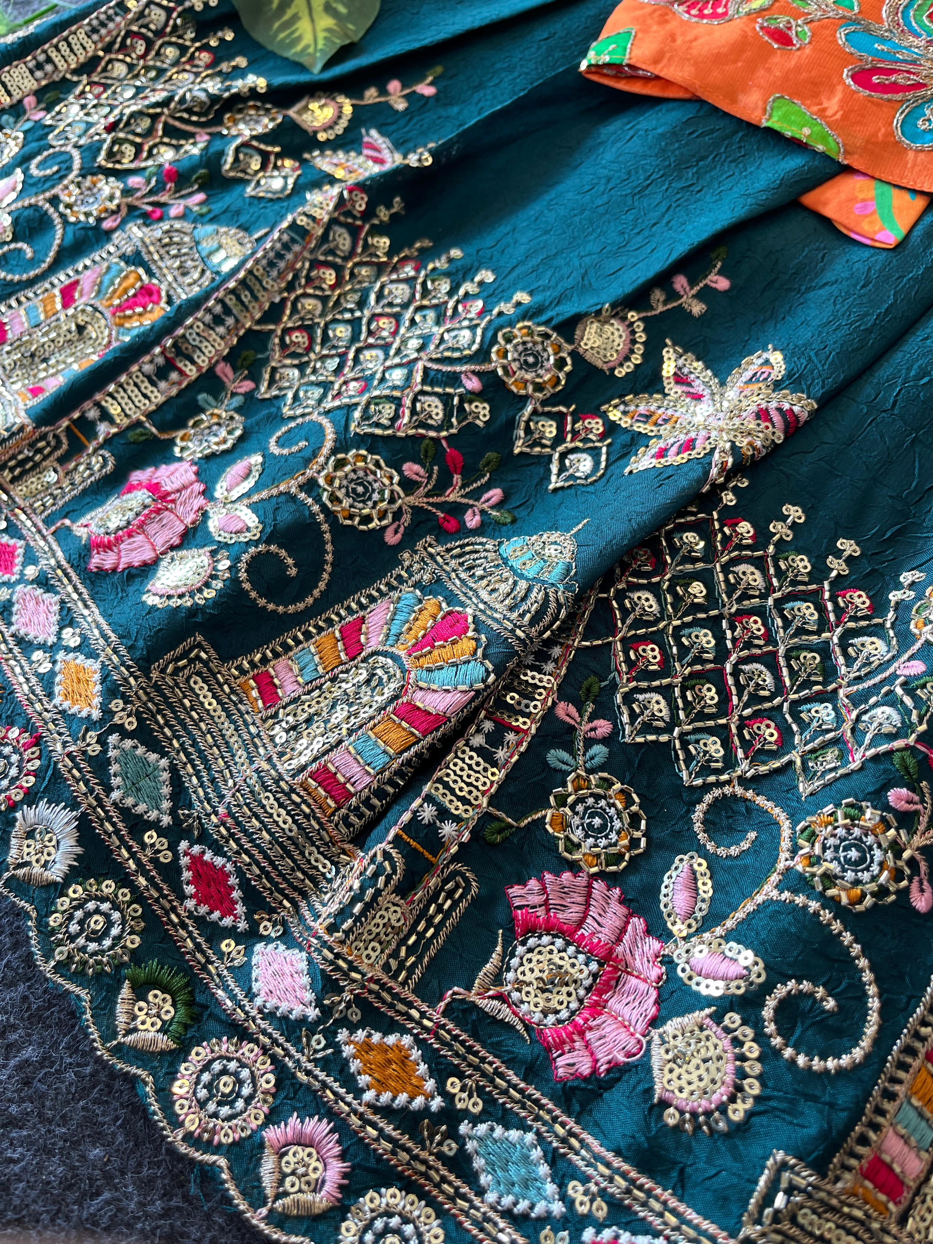 Rama Green embroidered fabric with floral and geometric patterns.