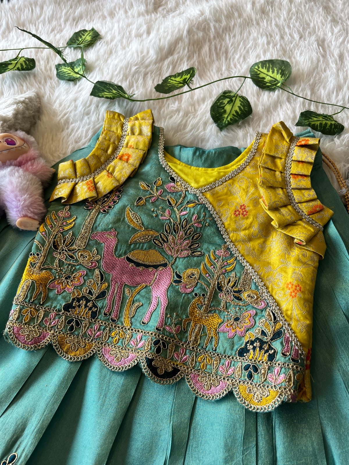 Cyan Embroiderey dress with floral and animal patterns on a background