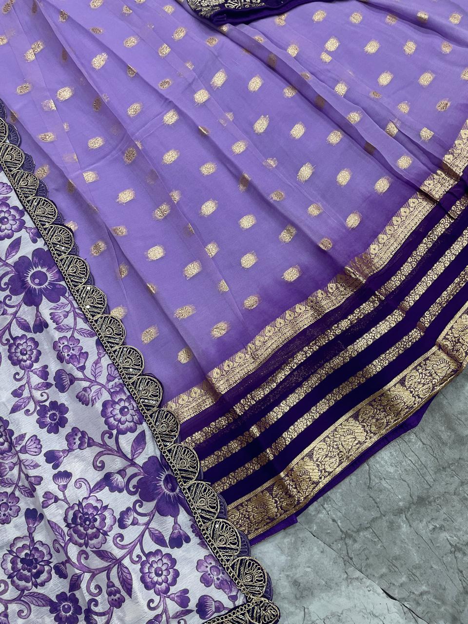 Purple saree with gold patterns on a gray surface
