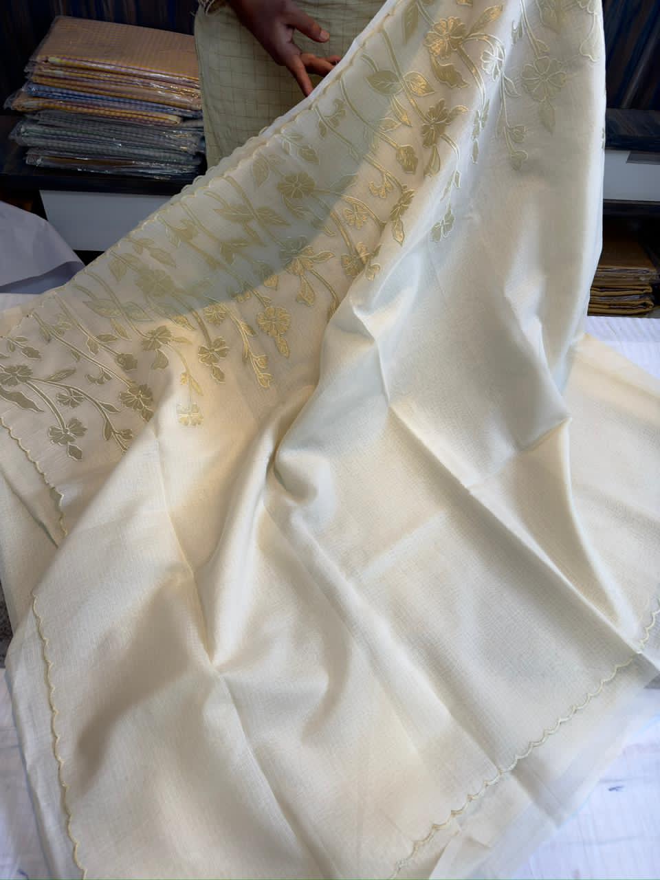 White fabric with gold embroidery patterns 