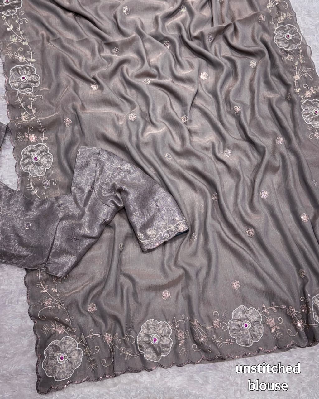Gray fabric with floral embroidery on a textured surface