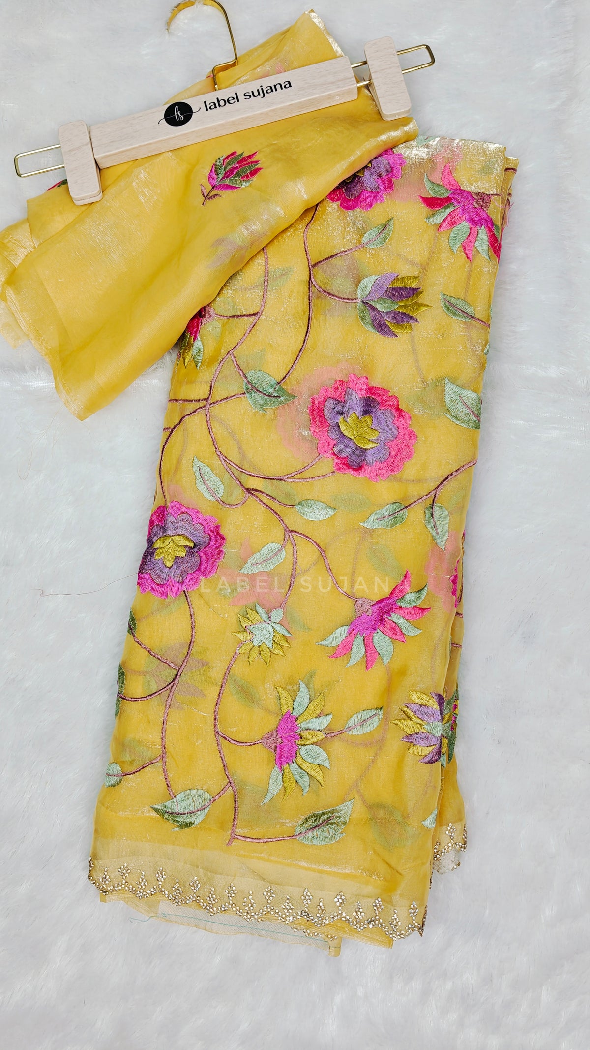 A yellow embroidered saree with matching blouse