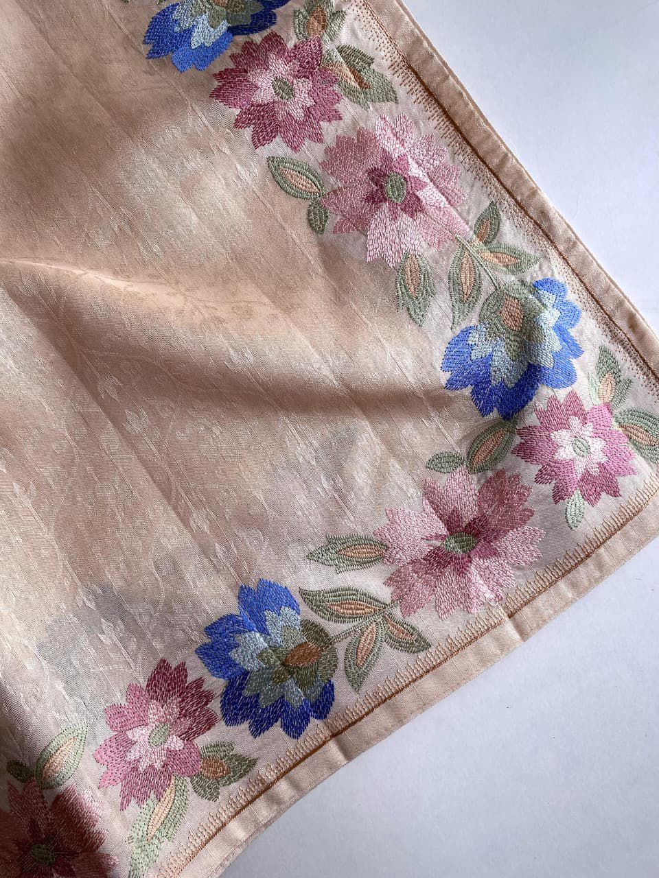 Beige fabric with floral patterns on a beige background