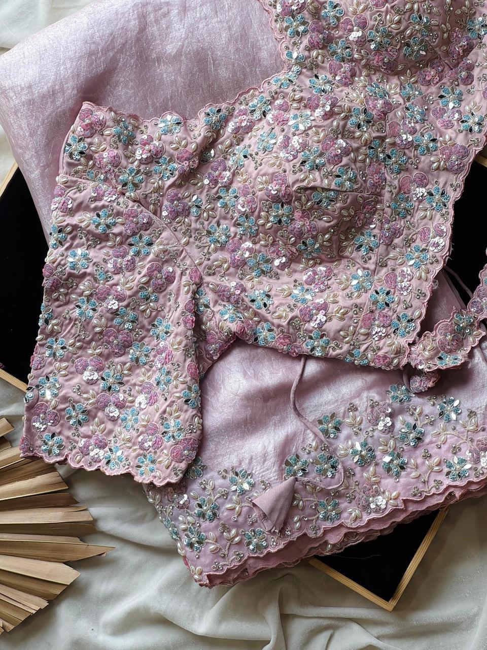 Blush Pink embroidered garment on a light pink fabric background